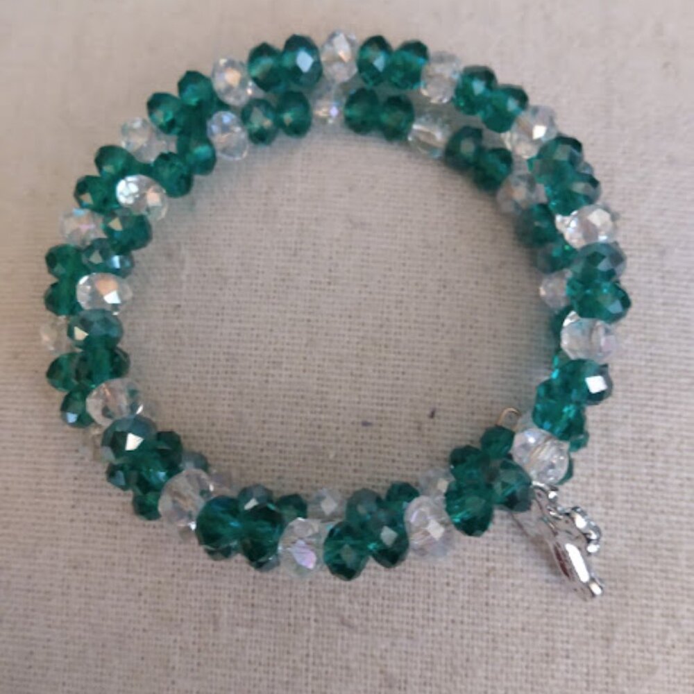 Wire wrap rhinestone bracelet with green & clear stones and a cross charm.